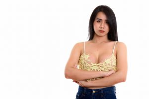 Studio shot of young Asian transgender woman with arms crossed isolated against white background